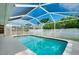 Inviting screened-in pool featuring a ladder for easy access, surrounded by a well-maintained patio at 1536 Porpoise Rd, Venice, FL 34293
