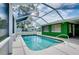Screened-in pool with patio and a serene backyard view, perfect for relaxation and outdoor enjoyment at 1536 Porpoise Rd, Venice, FL 34293