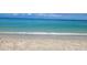Beautiful beach with soft sand and clear turquoise water under a partly cloudy sky at 1608 E Cypress Point Dr, Venice, FL 34293