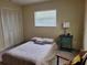 Bright bedroom with a twin bed and chair at 1608 E Cypress Point Dr, Venice, FL 34293