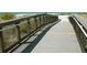 Wooden boardwalk pathway with railings leading to a beautiful beach at 1608 E Cypress Point Dr, Venice, FL 34293