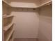 A well-organized walk-in closet featuring shelving and hanging space for clothes and accessories at 1608 E Cypress Point Dr, Venice, FL 34293