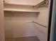 A spacious walk-in closet with rod, shelves, and ample storage space for clothes and personal belongings at 1608 E Cypress Point Dr, Venice, FL 34293