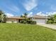 Charming single story home with an attached garage and mature landscaping at 1608 E Cypress Point Dr, Venice, FL 34293