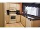 Eat-in kitchen with white cabinets and tile flooring at 1608 E Cypress Point Dr, Venice, FL 34293