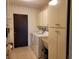 Functional laundry room with a sink, cabinets, washer, and dryer for convenient household chores at 1608 E Cypress Point Dr, Venice, FL 34293