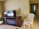 Comfortable living room with tile flooring and a media center at 1608 E Cypress Point Dr, Venice, FL 34293