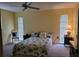 Cozy bedroom with queen-sized bed and views of the yard at 1608 E Cypress Point Dr, Venice, FL 34293