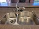 Close-up of stainless steel double sink and faucet at 1608 E Cypress Point Dr, Venice, FL 34293