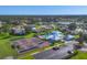 An aerial view of the tennis courts, clubhouse, pool and parking available to homeowners at 1614 Quail Lake Dr, Venice, FL 34293