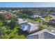 Aerial view of property featuring a well-maintained lawn and a white roof at 1614 Quail Lake Dr, Venice, FL 34293