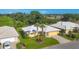 Aerial view of a well-kept home featuring a new roof, palm trees, and lush greenery at 1614 Quail Lake Dr, Venice, FL 34293