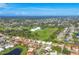 Panoramic aerial view showing the community's layout, surrounding landscape, and proximity to amenities at 1614 Quail Lake Dr, Venice, FL 34293