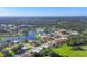 Wide aerial view showcases a community featuring waterways and lush landscaping at 1614 Quail Lake Dr, Venice, FL 34293