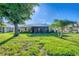 Lush green lawn with palm trees surrounds lanai for outdoor enjoyment at 1614 Quail Lake Dr, Venice, FL 34293