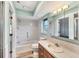 Well-lit bathroom with tub-shower combo, tile surround, and a single sink vanity at 1614 Quail Lake Dr, Venice, FL 34293