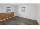 Bright bedroom with wood-look vinyl floors, and natural light from two windows at 1614 Quail Lake Dr, Venice, FL 34293