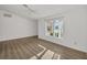 Bright, spacious bedroom with light wood-look floors, neutral walls, and a large window at 1614 Quail Lake Dr, Venice, FL 34293