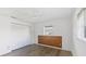 White bedroom featuring neutral walls, wood-look vinyl floors, and a closet at 1614 Quail Lake Dr, Venice, FL 34293