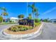 Community entrance sign surrounded by flowers and manicured landscaping at 1614 Quail Lake Dr, Venice, FL 34293