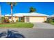 Inviting single-Gathering home featuring a new roof, palm trees, and a sunny yellow exterior paint at 1614 Quail Lake Dr, Venice, FL 34293