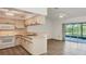 Bright kitchen open to living space with stainless appliances, a breakfast bar, and sliding glass doors to lanai at 1614 Quail Lake Dr, Venice, FL 34293