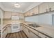 Efficient kitchen featuring ample counter space, white appliances, and white cabinets at 1614 Quail Lake Dr, Venice, FL 34293