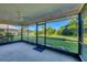 Enclosed screened patio with ceiling fan provides a relaxing outdoor living space and peaceful backyard views at 1614 Quail Lake Dr, Venice, FL 34293
