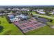 Overhead shot of tennis and pickle ball courts near a community pool and clubhouse at 1614 Quail Lake Dr, Venice, FL 34293
