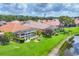 Beautiful aerial view of a home with a screened-in pool and lush green lawn in a tranquil community at 1620 San Silvestro Dr, Venice, FL 34285