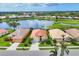 Aerial view of the home showing the tile roof, landscaping, lake view, and surrounding neighborhood at 1620 San Silvestro Dr, Venice, FL 34285