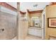 Bathroom with tile shower, vanity, and framed mirror, exuding functionality at 1620 San Silvestro Dr, Venice, FL 34285