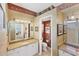 Bright bathroom showcasing a vanity, framed mirrors, and an adjacent water closet at 1620 San Silvestro Dr, Venice, FL 34285