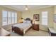Comfortable bedroom featuring plantation shutters and a decorative ceiling fan at 1620 San Silvestro Dr, Venice, FL 34285