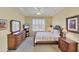 Well-lit bedroom featuring plantation shutters and stylish wood furnishings at 1620 San Silvestro Dr, Venice, FL 34285