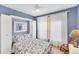 Charming blue bedroom with a murphy bed and cozy furniture arrangement at 1620 San Silvestro Dr, Venice, FL 34285