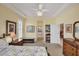 Bright, airy bedroom with tray ceilings, plantation shutters, and archway views at 1620 San Silvestro Dr, Venice, FL 34285