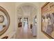 Elegant foyer leads into the main living areas, showcasing tile flooring and decorative mirrors at 1620 San Silvestro Dr, Venice, FL 34285