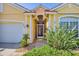 Inviting front entrance featuring mature landscaping and a decorative glass front door at 1620 San Silvestro Dr, Venice, FL 34285