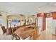 Open kitchen with granite counters, island seating, and stainless sink at 1620 San Silvestro Dr, Venice, FL 34285