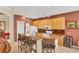 Stylish kitchen featuring granite countertops, wooden cabinetry, and seating at island at 1620 San Silvestro Dr, Venice, FL 34285