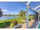 Lakeside view from patio showcasing a serene lake, landscaping and clear blue skies at 1620 San Silvestro Dr, Venice, FL 34285