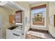 Bright laundry room with storage, window, and washer/dryer at 1620 San Silvestro Dr, Venice, FL 34285
