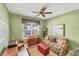 Cozy living room with floral sofa, vintage furniture, and a ceiling fan at 1620 San Silvestro Dr, Venice, FL 34285
