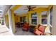 Covered patio and exterior view with ceiling fans, seating, and outdoor dining space at 1620 San Silvestro Dr, Venice, FL 34285