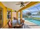Covered outdoor patio with dining area and scenic pool and water views at 1620 San Silvestro Dr, Venice, FL 34285