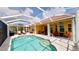 Inviting screened-in pool with patio, comfortable seating, and well-maintained landscaping at 1620 San Silvestro Dr, Venice, FL 34285