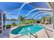 Beautiful pool and deck with scenic views of the lake and palm trees at 1620 San Silvestro Dr, Venice, FL 34285