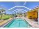 Relaxing screened-in pool area with lounge chairs and sunny views at 1620 San Silvestro Dr, Venice, FL 34285