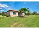 Inviting backyard with green lawn, tasteful landscaping and screened-in lanai for outdoor enjoyment at 20370 Grazie Pl, Venice, FL 34293